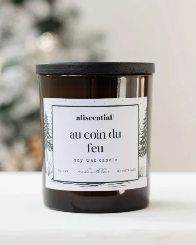 Scented candle by the fire. Aliscential in brown glass, packshot on pure background.